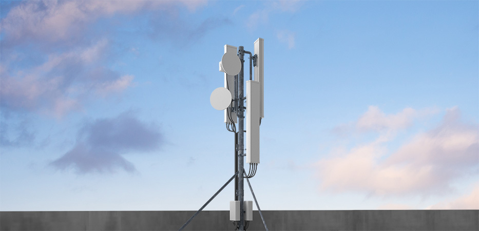 Photo of a 5G tower with mmWave, set against a blue sky background.