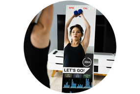 Woman exercing with a smart technology exercise mirror.