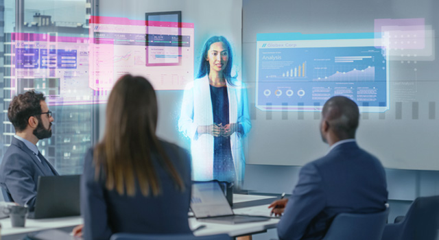 People in an office seeting during a mixed reality and virtual communications meeting.
