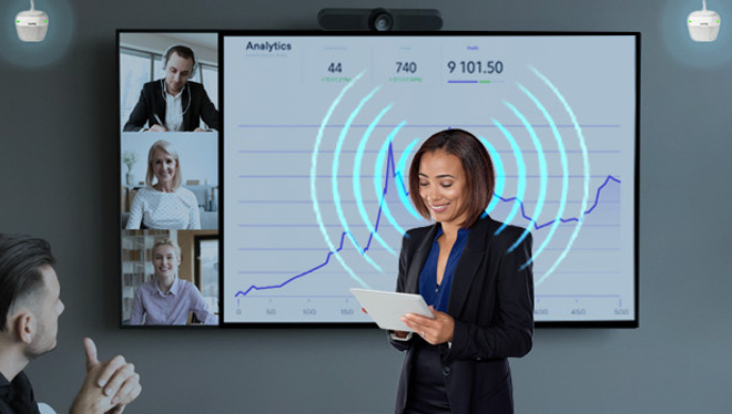 A woman with blue sound waves coming from her mouth as she presenting during a meeting and a pair of biam speakers detecting her voice.