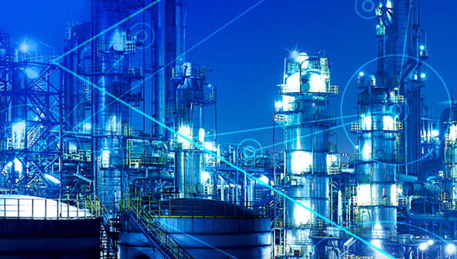 Image shows a gas refinery production plant at night.