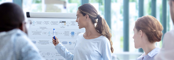 Leader discusses whiteboard diagram with a group
