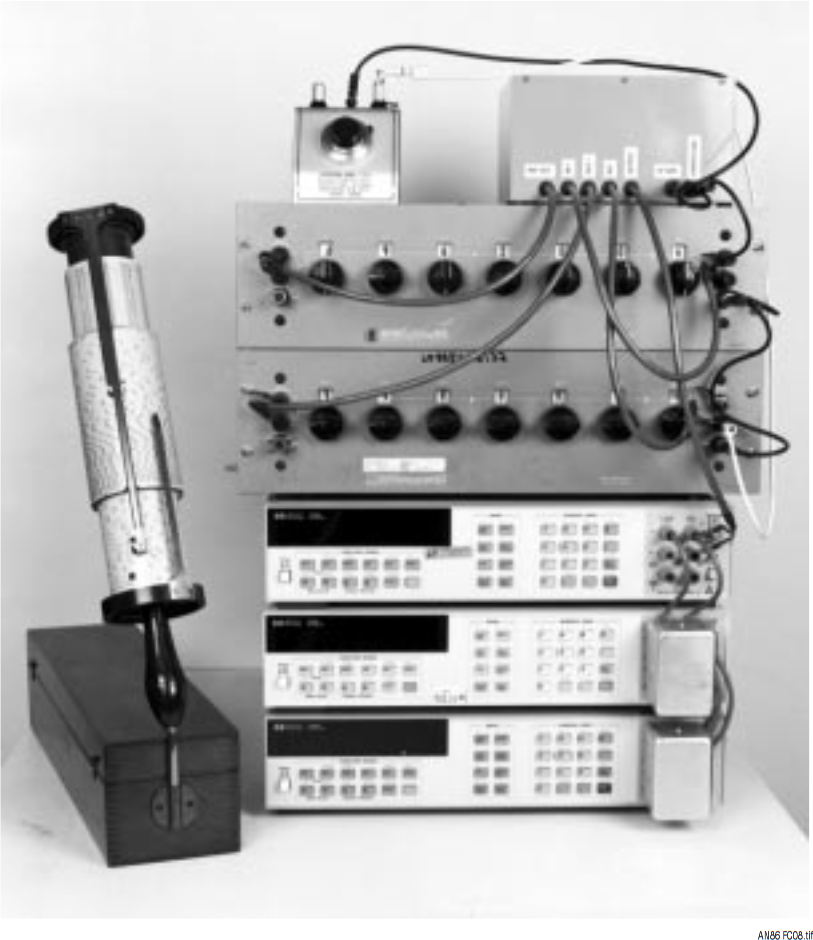 Figure C8. The Sub-ppm Linearity Voltage Source. Box Upper Right Is LTZ1000A Based Reference and Buffers. Upper Left Is Offset Trim. Reference and Main Kelvin-Varley Dividers Are Photo Center—Upper and Center-Middle, Respectively. Three HP3458 DVMs (Photo Lower) Monitor Output. Computer (Left Foreground) Aids Linearity Calculations.