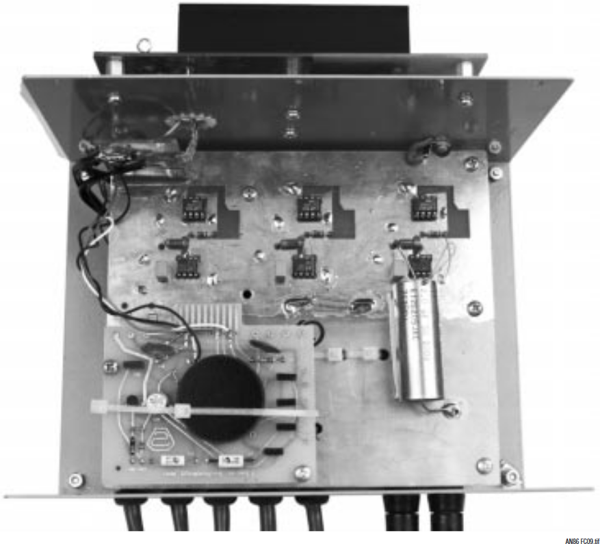 Figure C9. Reference-Buffer Box Construction. LTZ1000A Reference Circuitry Is Photo Lower Left, Buffer Amplifiers Photo Center. Note Capacitor Case Bootstrap Connection (Photo Center—Right). Single Point Ground Mecca Appears Photo Upper Left. Power Supply (Photo Top) Mounts Outside Box, Minimizing Magnetic Field Disturbance.
