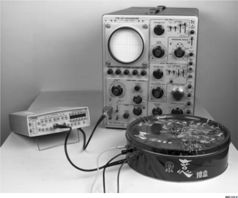 Figure H3. Noise Measurement Test Setup Includes Shielded DAC Breadboard (Foreground), Preamplifier (Left) and Low Pass Filter Attached to Oscilloscope (Center). Measurement Path Is Fully Coaxial.