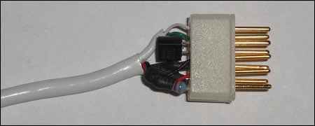 Figure 2. DB9 connector with embedded TO92 1-Wire device before injection molding.