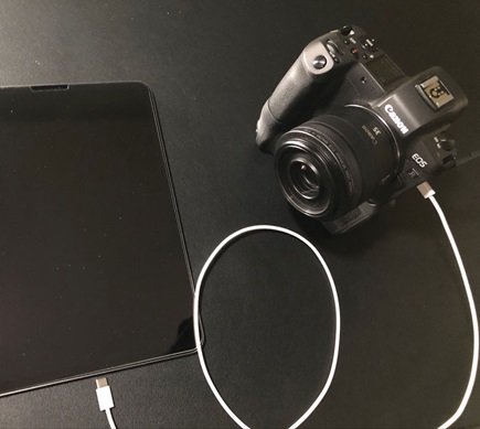 Figure 1. A digital camera connected to a tablet via a USB-C cable.