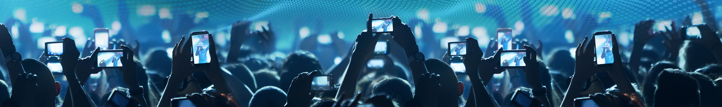 People filming with smartphones during a concert