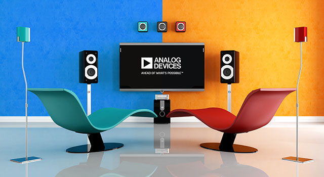Modern living room with curved chairs, blue and orange wall, and stereo speakers.
