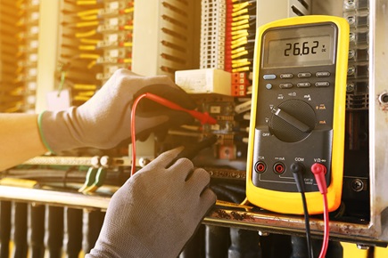 Figure 1. A technician performing calibration at a wiring cabinet.