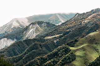Scenic view of lush green mountains, symbolizing natural resources and environmental conservation.