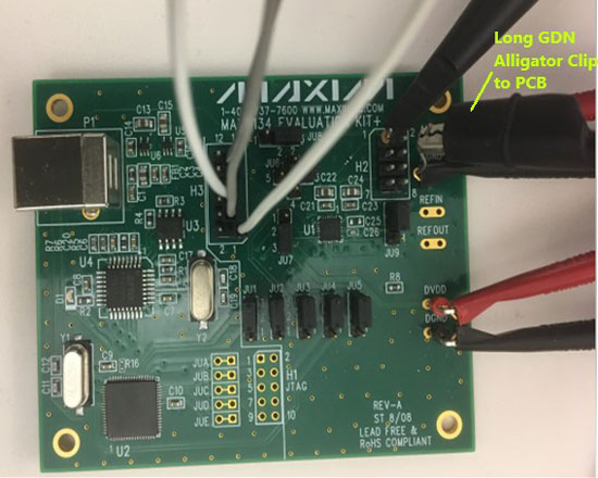 MAX5134 glitch impulse measurement using a standard scope probe with a long alligator clip ground connection to the PCB