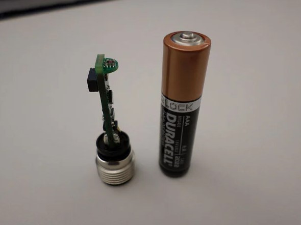 Figure 2. The Santa Cruz reference design next to a standard AAA battery.