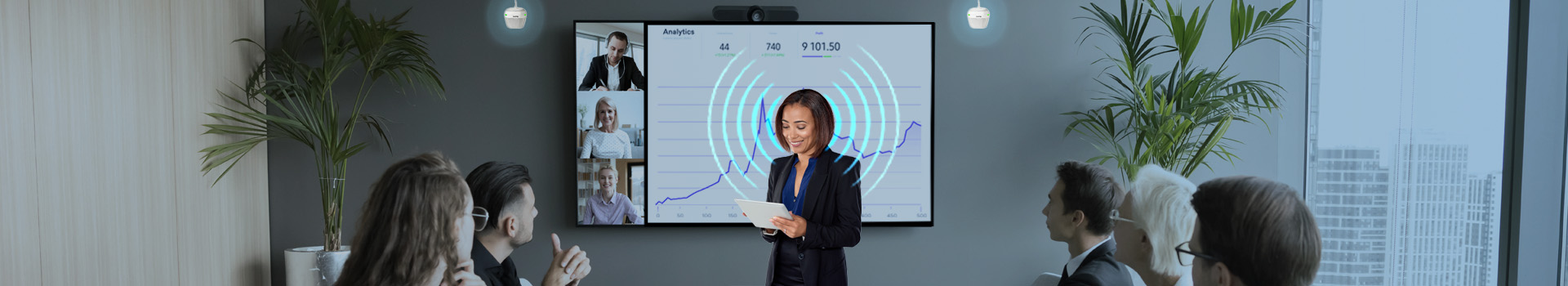 A woman with blue sound waves coming from her mouth as she presenting during a meeting and a pair of biam speakers detecting her voice.