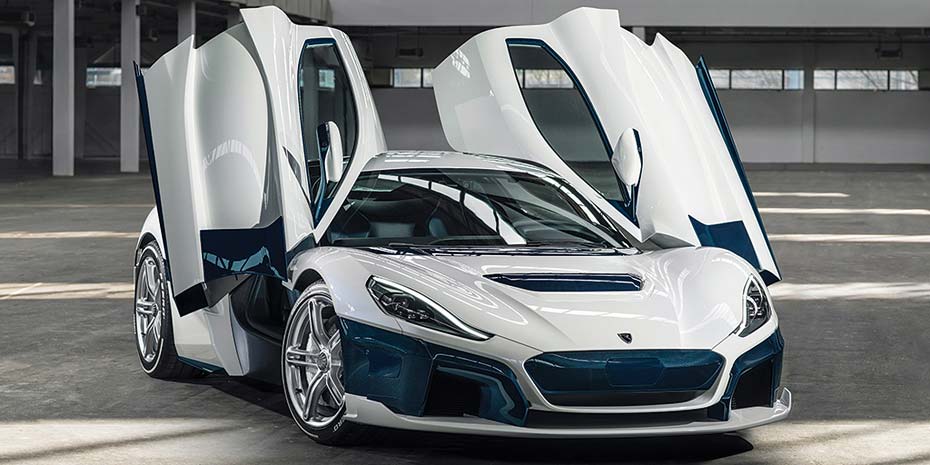 Shiny white and blue Ferrari sports car with doors open in a garage