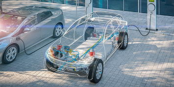 electric car with battery visible charging at public charger in a parking lot