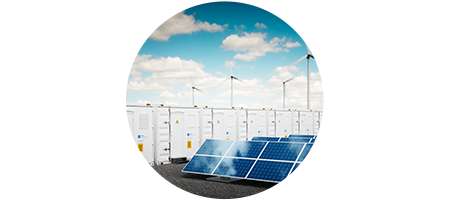 Solar panels, wind turbines and electric energy storage containers with sunny day and blue skies in background.