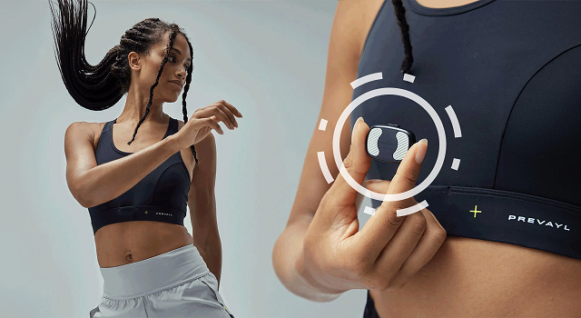 A woman in sports bra and shorts moving and holding Prevayl Sensor